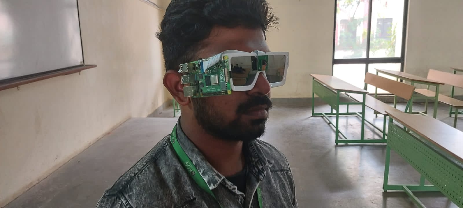 The eyewear prototype worn, camera and control board mounted on the frame